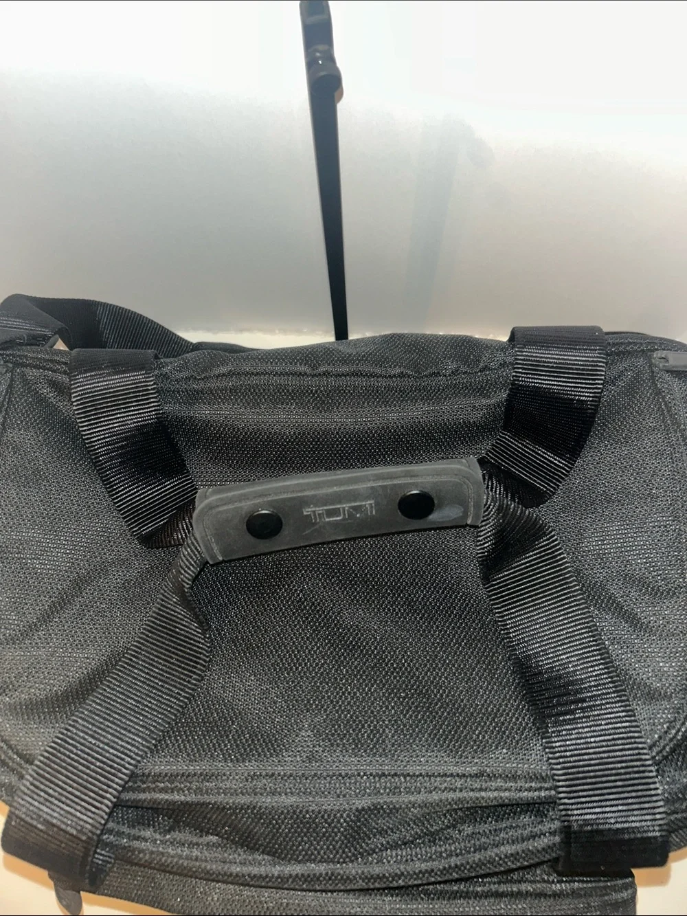 Tumi Black Duffel Bag with Red Logo Accent